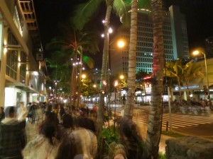 Busy Sidewalk at Night in Waikiki, Hawaii Busy Sidewalk at Night in Waikiki, Hawaii