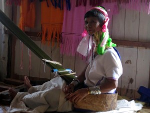 Long-neck Kayan woman working in Souvenir Shop at Inle Lake, Myanmar Long-neck Kayan woman working in Souvenir Shop at Inle Lake, Myanmar
