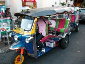 Typical Tuk Tuk with Driver on the Streets of Bangkok, Thailand Typical Tuk Tuk with Driver on the Streets of Bangkok, Thailand