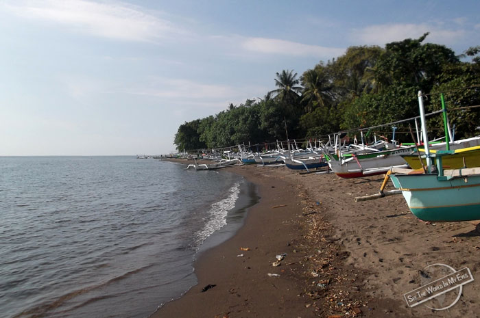 Grey Sand Beach and Local Fishing Boats by Seririt on Bali, Indonesia Grey Sand Beach and Local Fishing Boats by Seririt on Bali, Indonesia