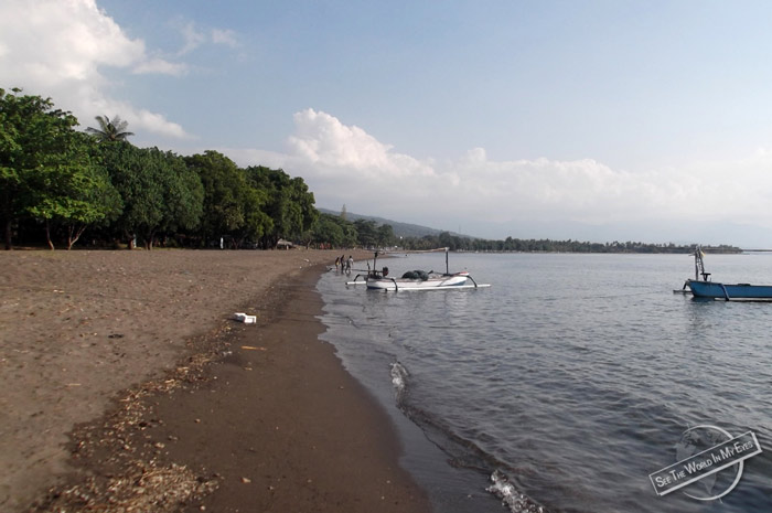 Empty Grey Sand Beach and Quiet Sea in Kalibukbuk on Bali, Indonesia Empty Grey Sand Beach and Quiet Sea in Kalibukbuk on Bali, Indonesia