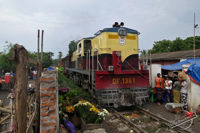 Myanmar Railways Train driving through a busy Market in Amarapura, Myanmar Myanmar Railways Train driving through a busy Market in Amarapura, Myanmar